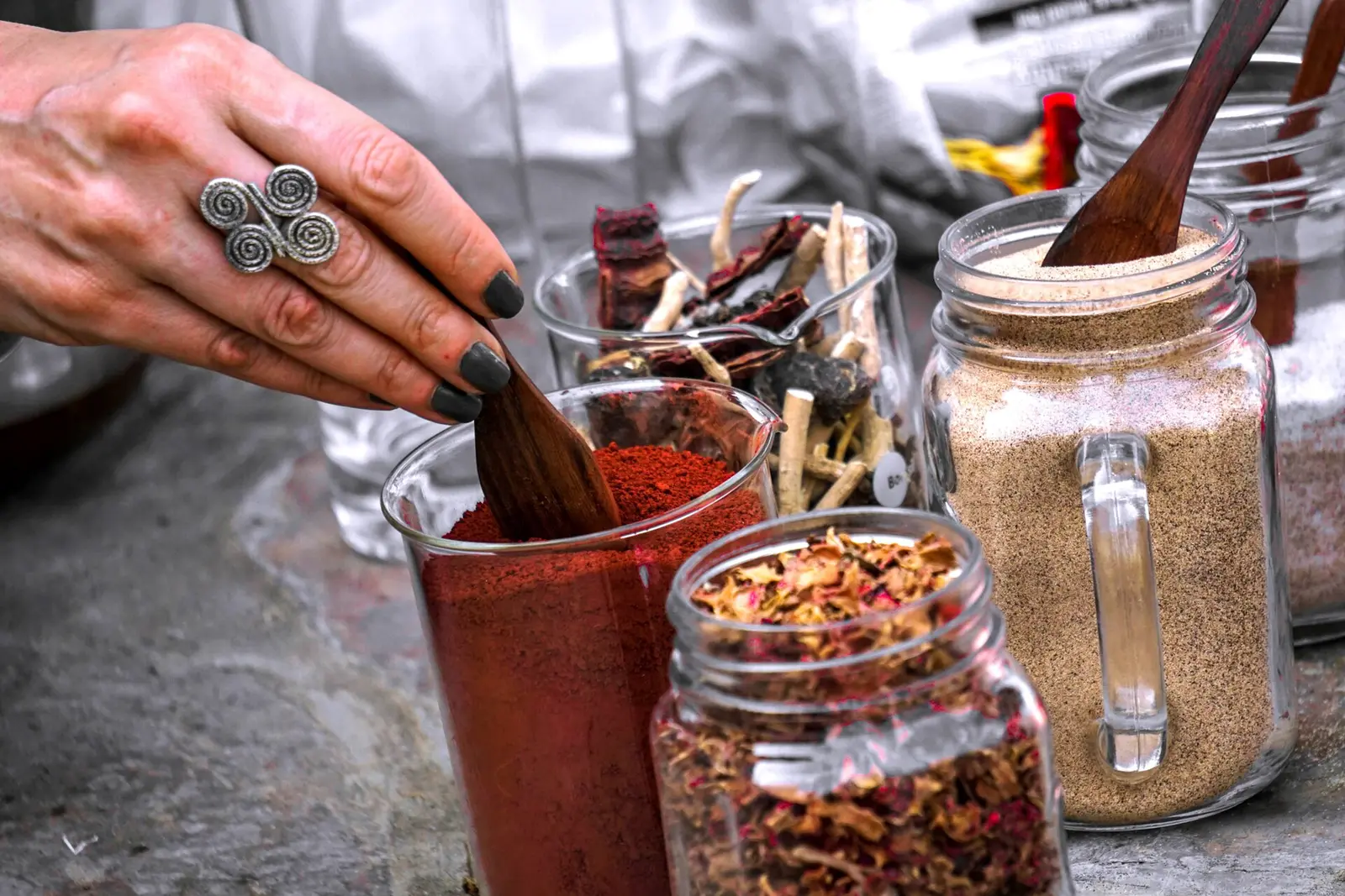 Hands preparing Ayurvedic herbs and spices